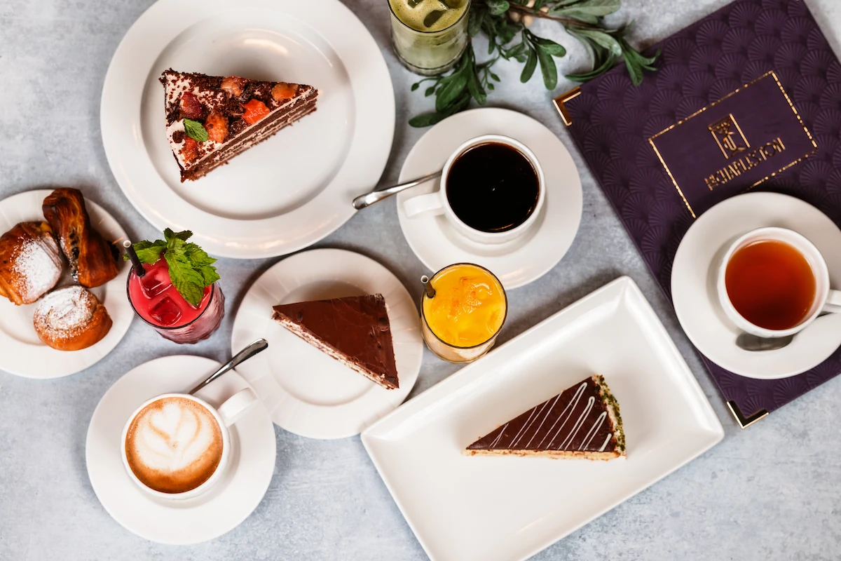 A selection of cakes and drinks on a table